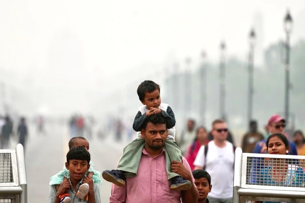 Public walking on a street covered in smog, in New Delhi PIC CREDIT: apnanews.com