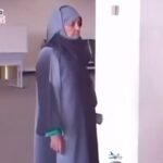 Woman at JFK Airport holding a passport from fictional country Torenza, immigration officers looking confused, viral passport mystery 2025